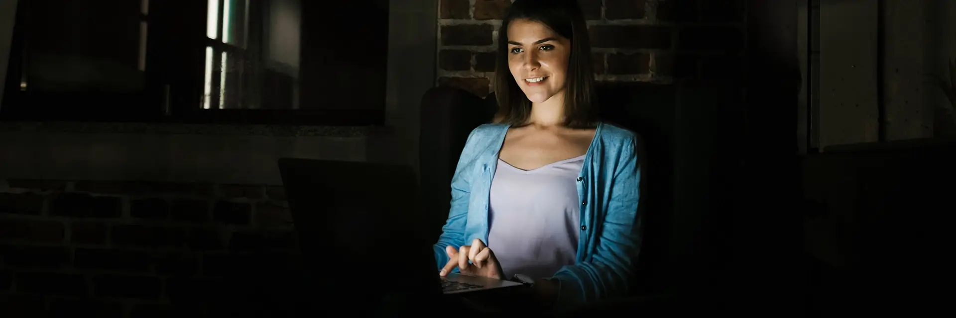 Woman smiling while using laptop